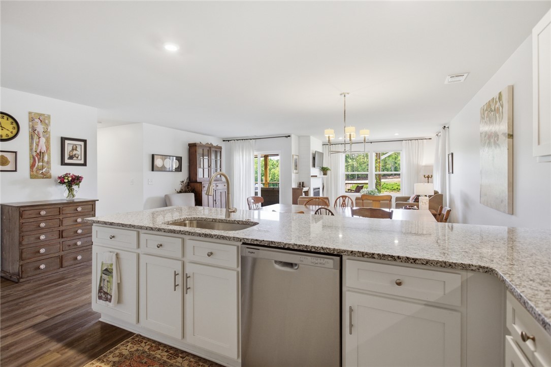 412 Chadwick Lane Walhalla, SC 29691 - Photo 10 of 37 The kitchen island, with its ample counter space and integrated sink, overlooks the inviting living area and offers views of the surrounding natural landscape.