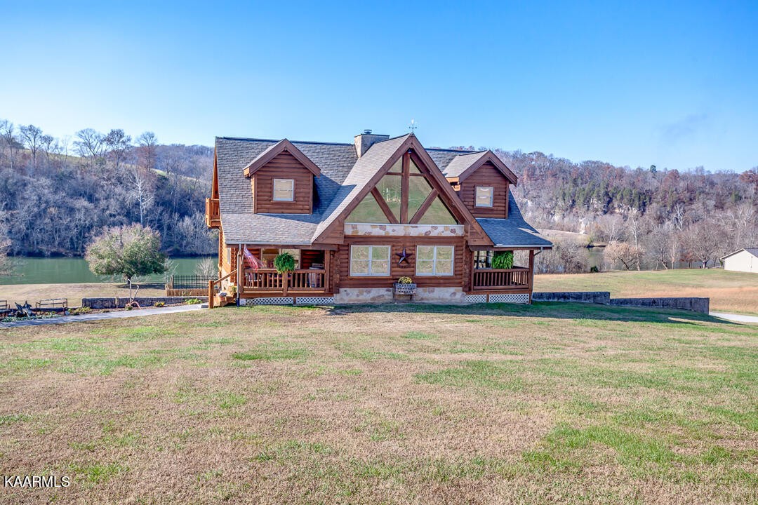 2030 Holston River Drive Rutledge, TN 37861 - Photo 2 of 53 a view of a house with a big yard and large trees