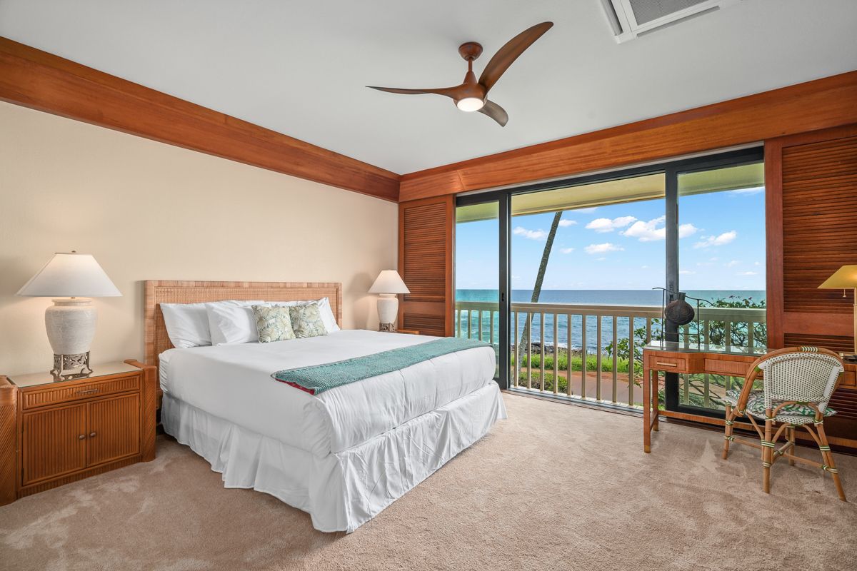 2221 Kapili Road, Unit 6 Koloa, HI 96756 - Photo 13 of 27 a bedroom with a bed and a large window