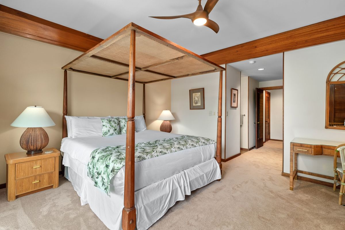 2221 Kapili Road, Unit 6 Koloa, HI 96756 - Photo 16 of 27 a bedroom with bed and a chandelier