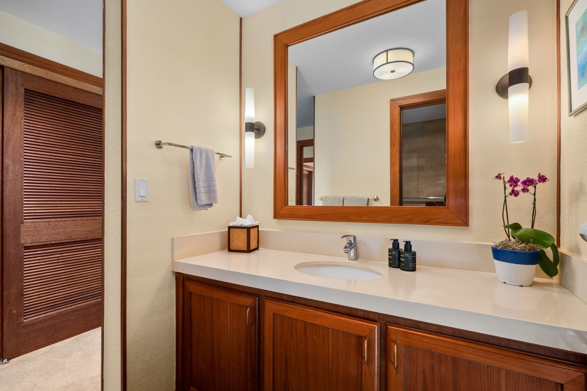 2221 Kapili Road, Unit 6 Koloa, HI 96756 - Photo 18 of 27 a bathroom with a sink and a mirror