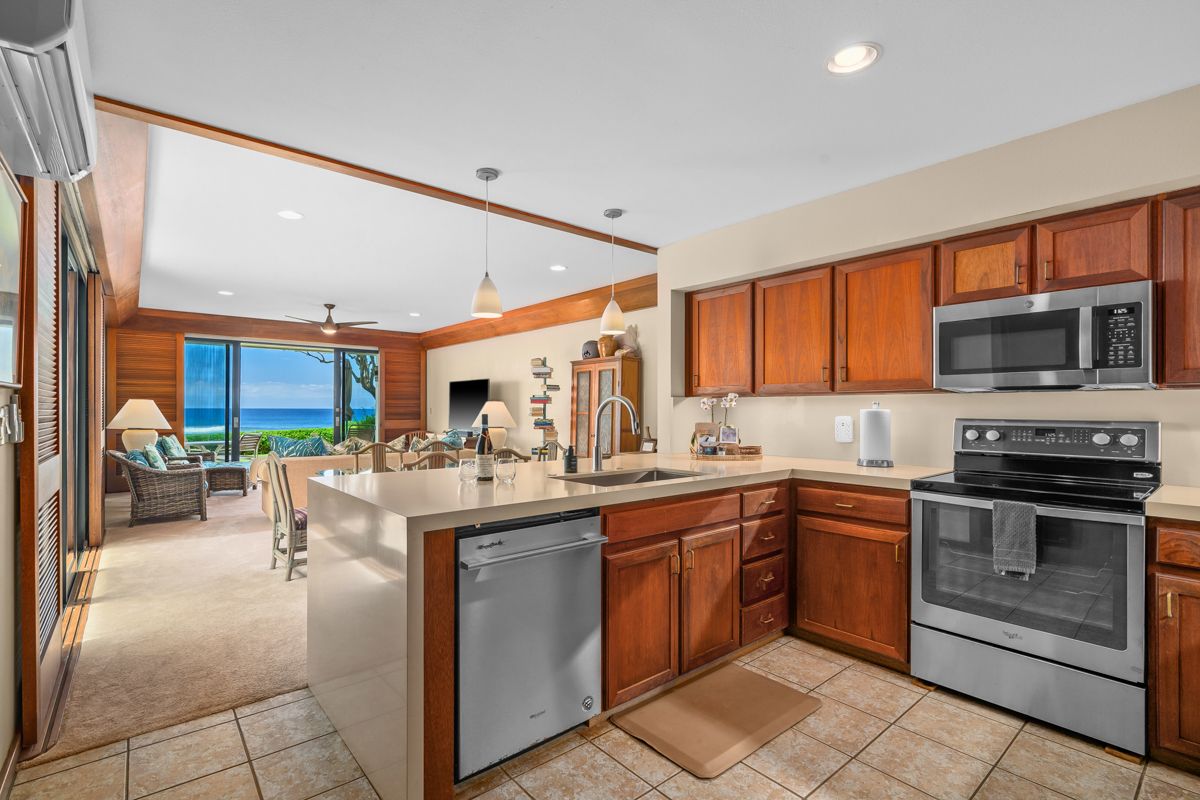 2221 Kapili Road, Unit 6 Koloa, HI 96756 - Photo 2 of 27 a kitchen with a sink stove and cabinets