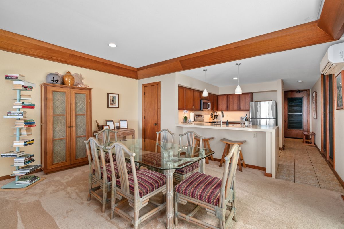 2221 Kapili Road, Unit 6 Koloa, HI 96756 - Photo 4 of 27 a dining room with furniture and a kitchen view