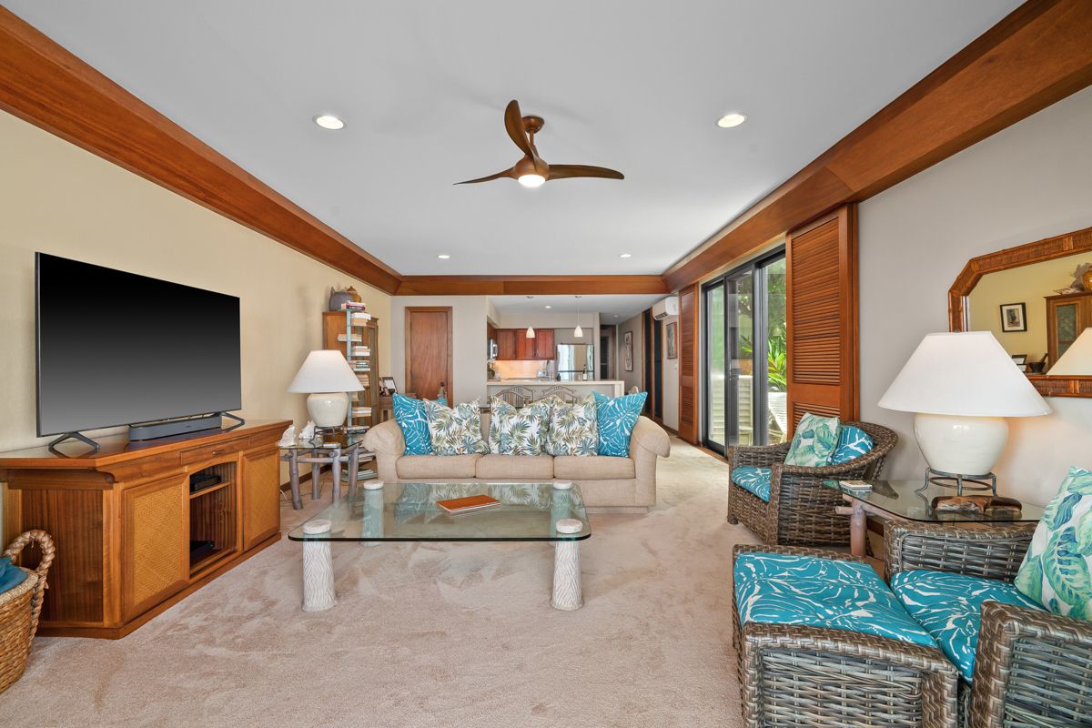 2221 Kapili Road, Unit 6 Koloa, HI 96756 - Photo 6 of 27 a living room with furniture a flat screen tv and a large window