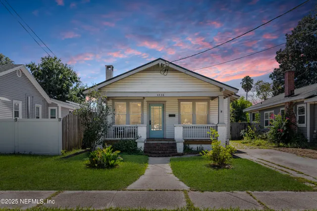 a front view of house with a garden