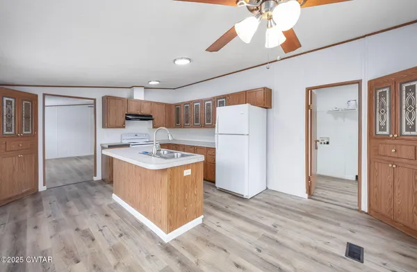 a kitchen with stainless steel appliances a stove a refrigerator and a sink
