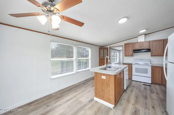 a kitchen with stainless steel appliances granite countertop a stove oven and a refrigerator