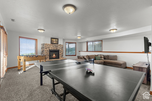 1340 Trapper Loop Garden City, UT 84028 - Photo 25 of 35 Rec room featuring carpet and a fireplace