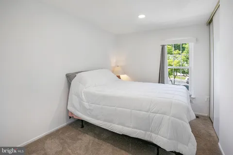 a bed sitting in a bedroom next to a window
