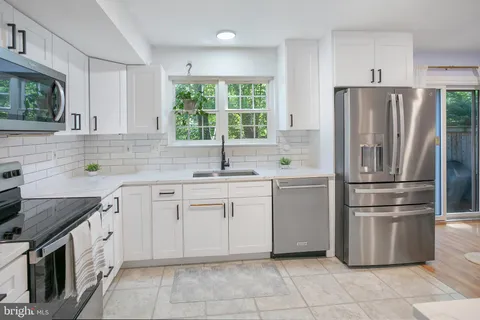 a kitchen with appliances cabinets and a sink
