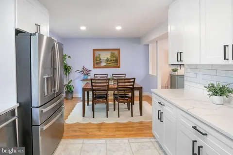 a view of kitchen with furniture and refrigerator
