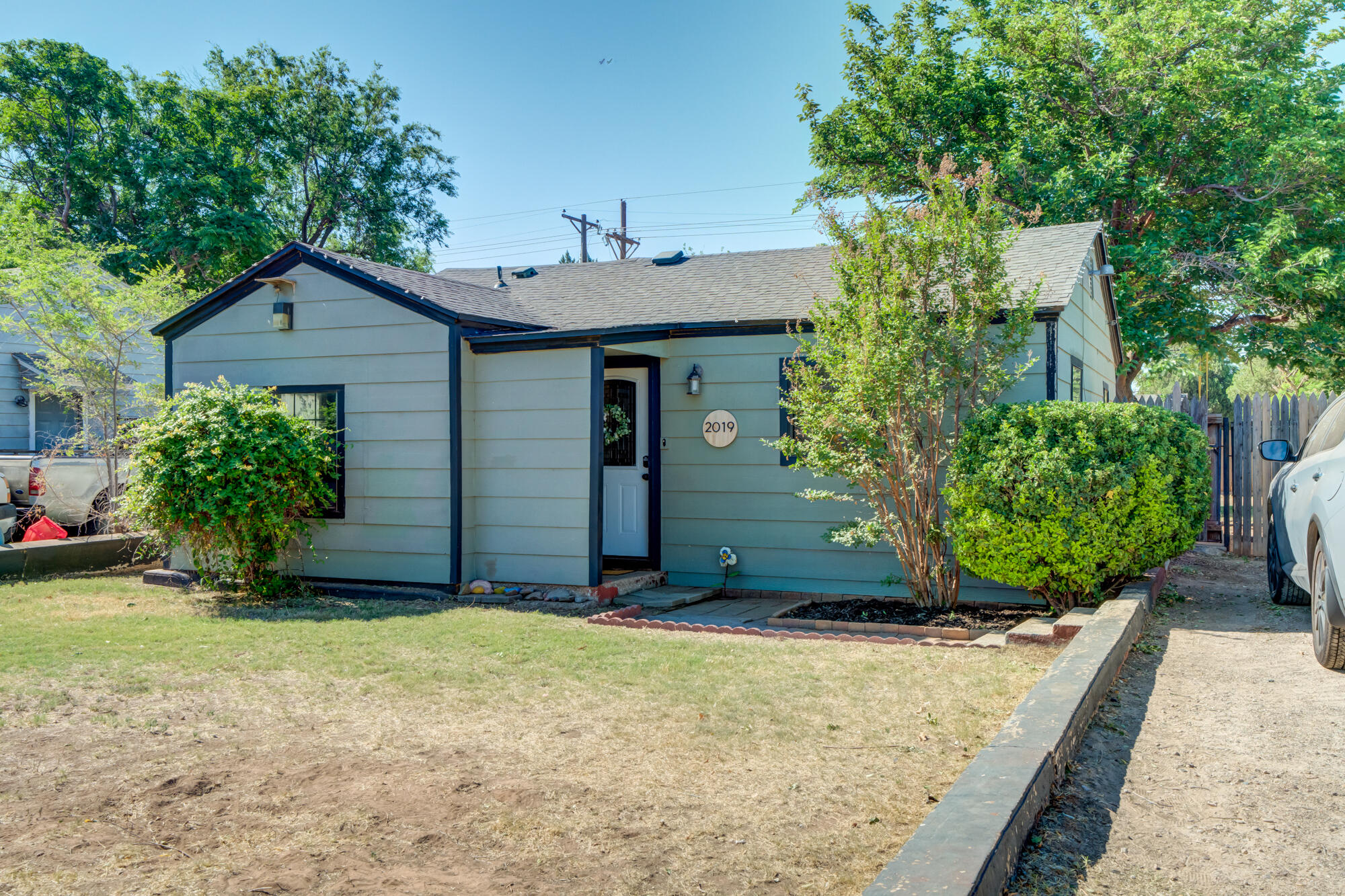 2019 40th Street Lubbock, TX 79412 - Photo 1 of 33 front view of a house with potted plants