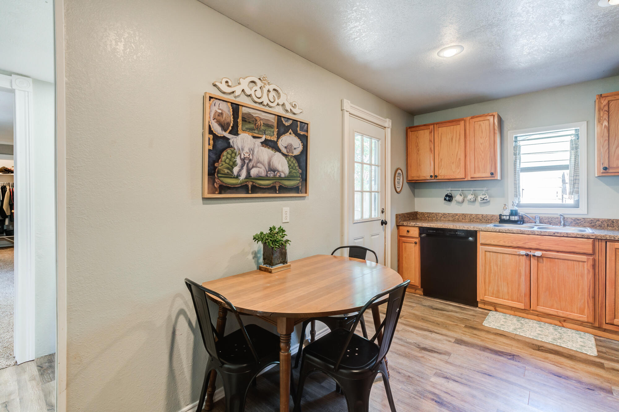 2019 40th Street Lubbock, TX 79412 - Photo 12 of 33 a view of a dining room with furniture and wooden floor