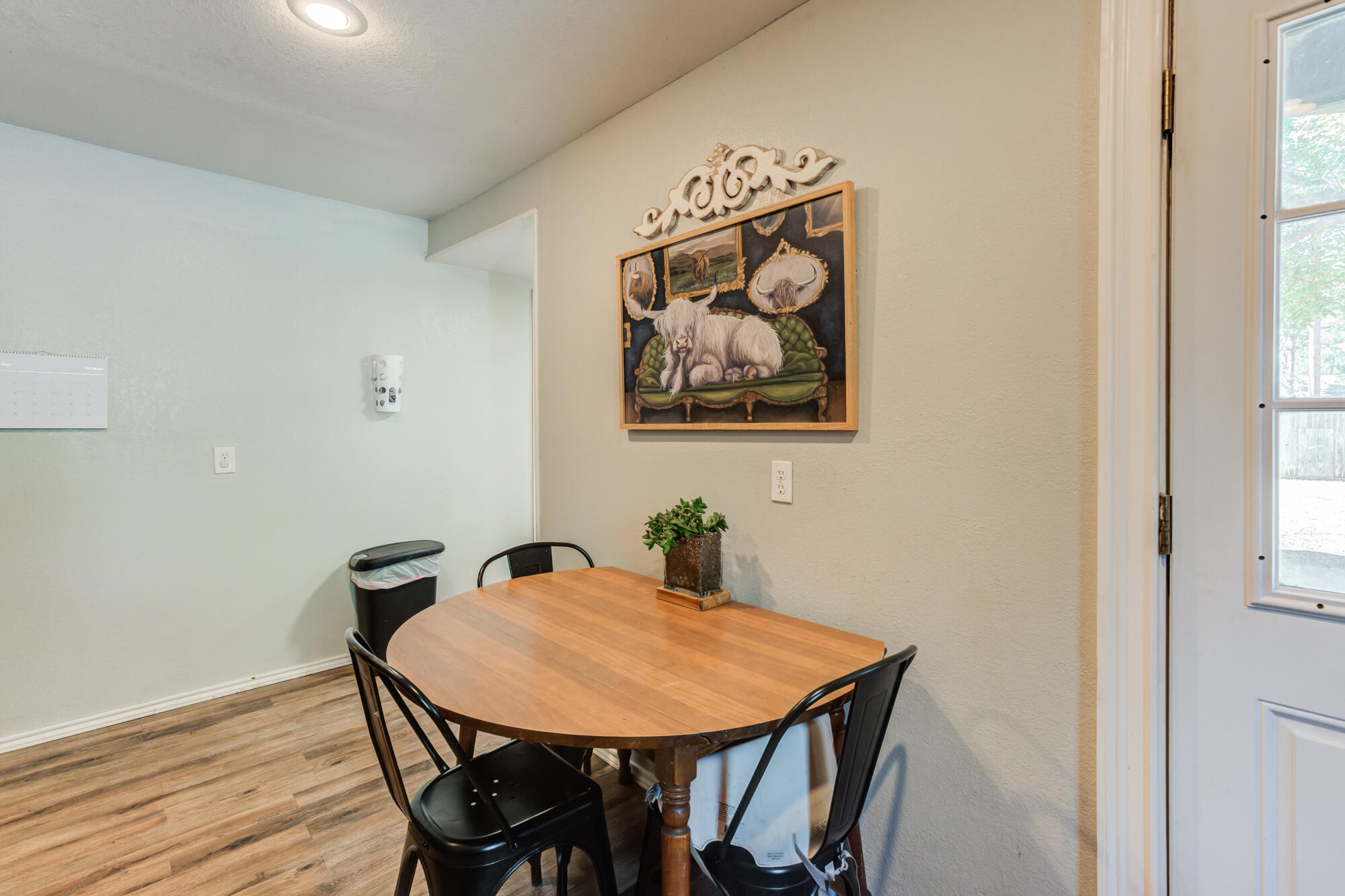 2019 40th Street Lubbock, TX 79412 - Photo 15 of 33 a view of a dining room with furniture and wooden floor