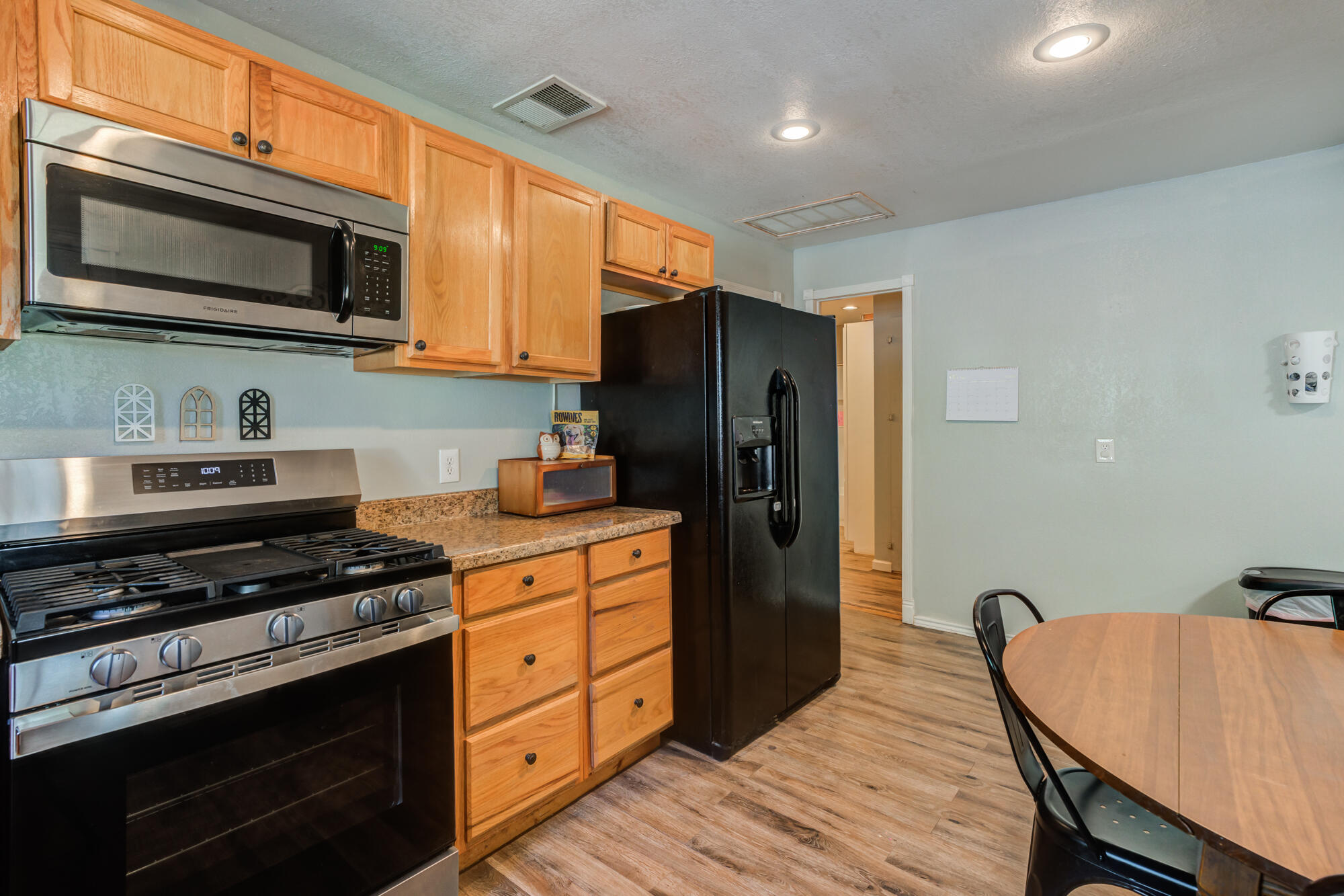 2019 40th Street Lubbock, TX 79412 - Photo 16 of 33 a kitchen with stainless steel appliances a stove microwave and refrigerator