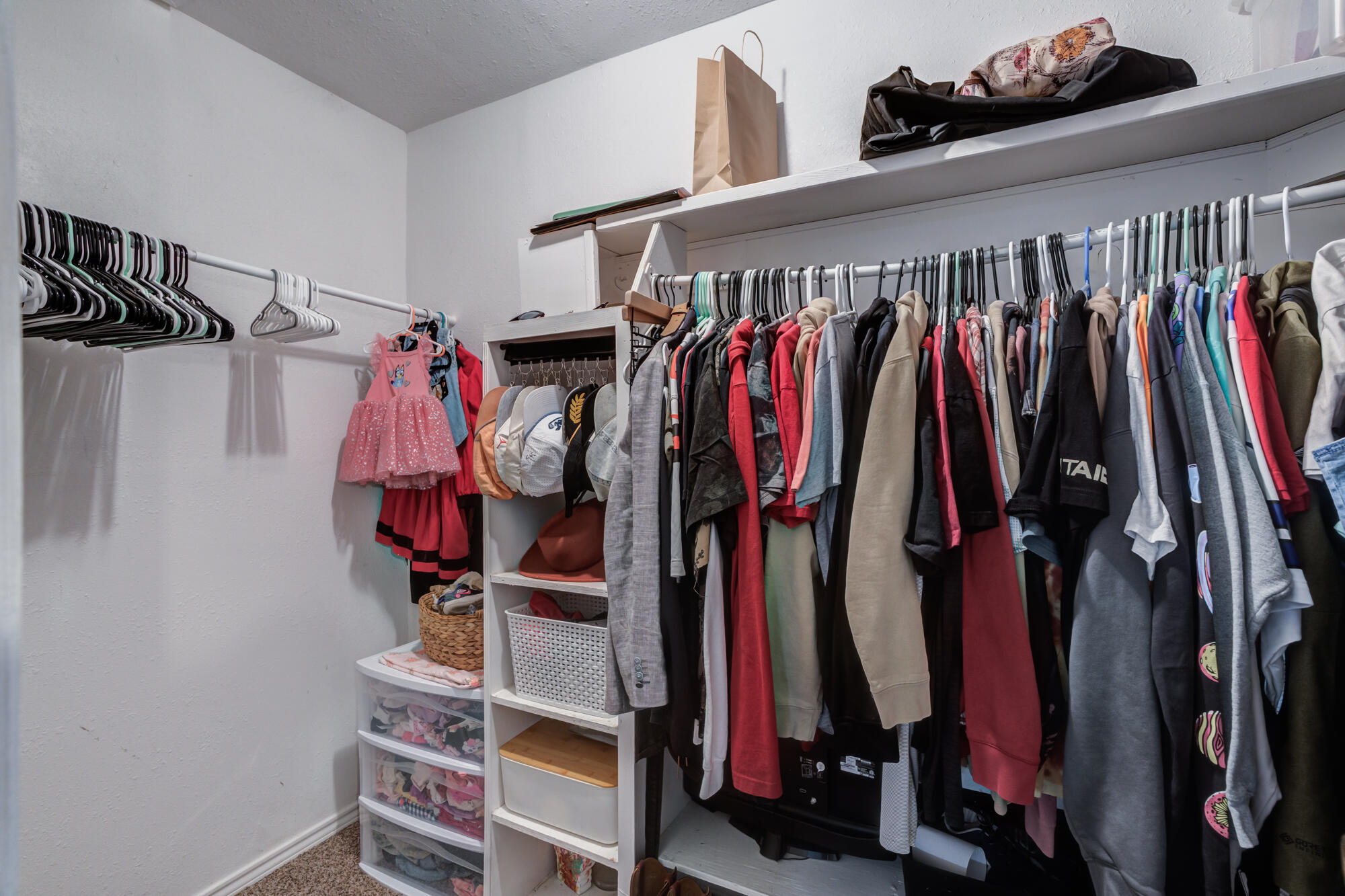 2019 40th Street Lubbock, TX 79412 - Photo 18 of 33 a view of walk in closet with clothes