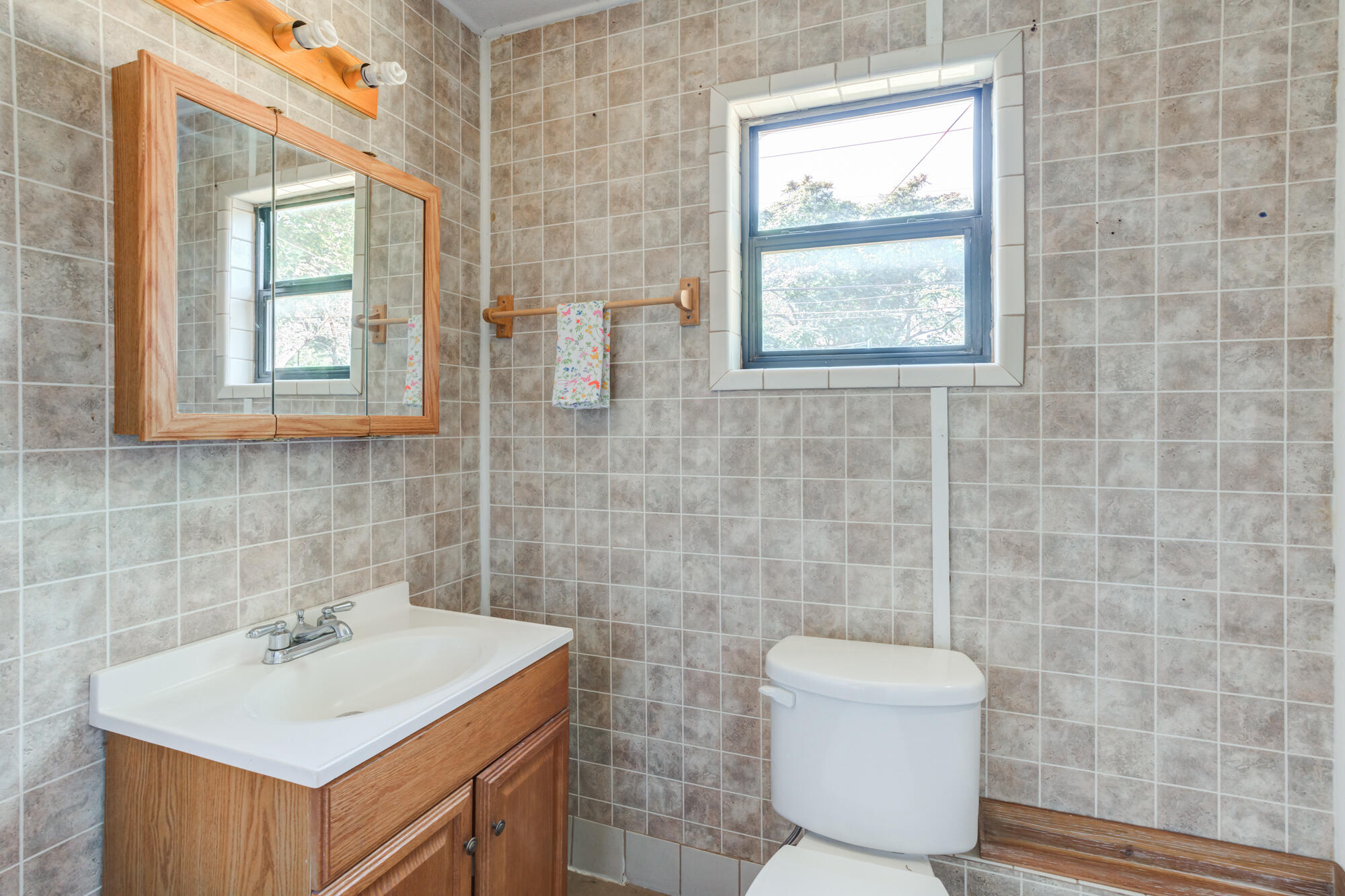 2019 40th Street Lubbock, TX 79412 - Photo 20 of 33 a bathroom with a toilet sink and mirror
