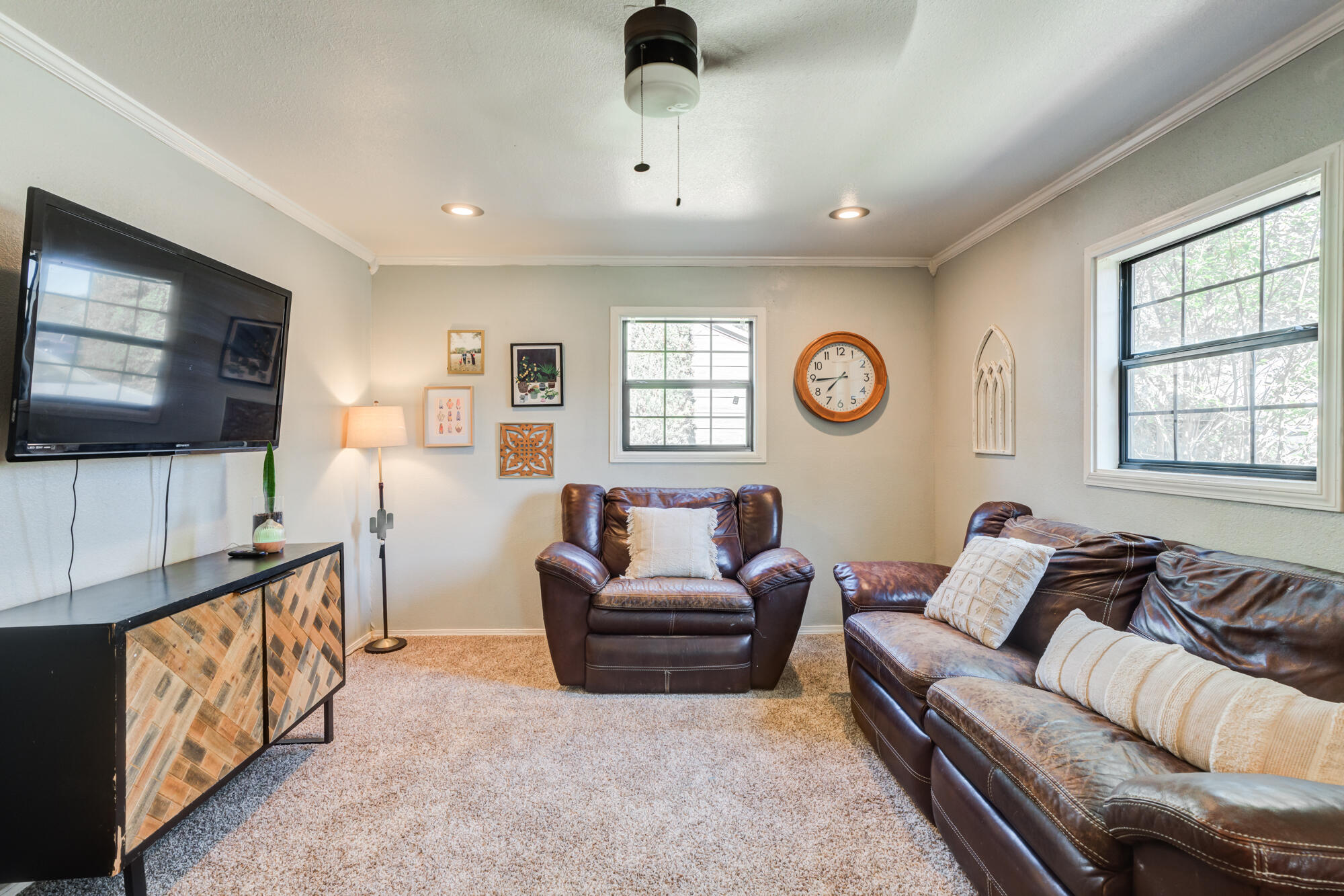 2019 40th Street Lubbock, TX 79412 - Photo 2 of 33 a living room with furniture and a flat screen tv
