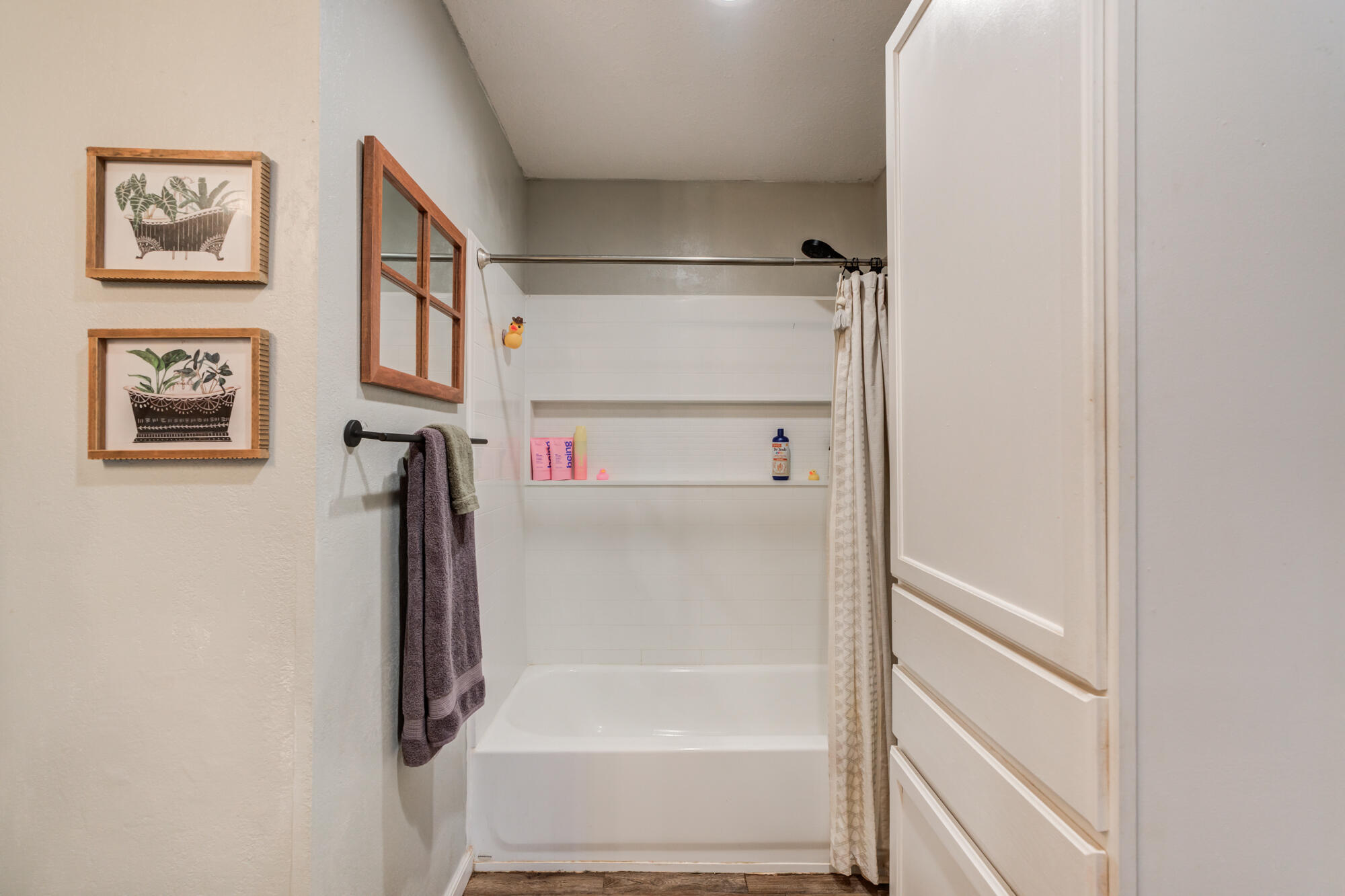 2019 40th Street Lubbock, TX 79412 - Photo 25 of 33 a bathroom with a bathtub and a shower