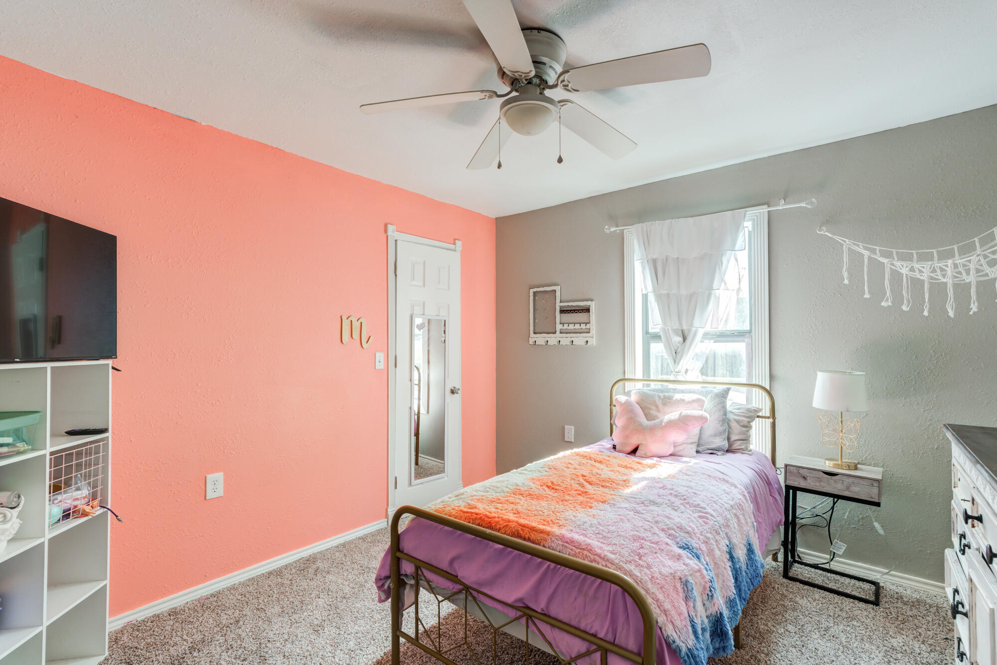 2019 40th Street Lubbock, TX 79412 - Photo 26 of 33 a bedroom with a bed and a chandelier