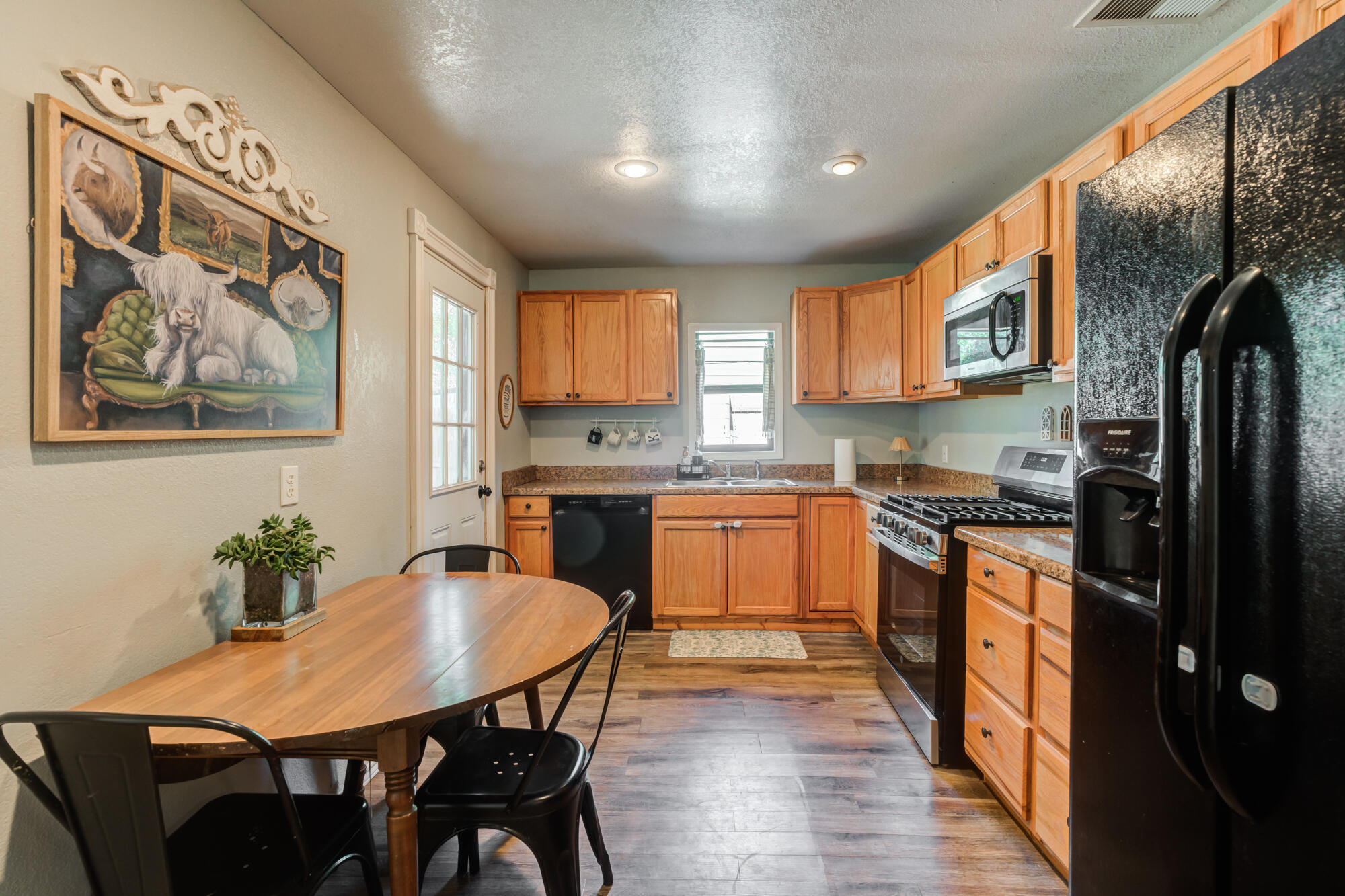 2019 40th Street Lubbock, TX 79412 - Photo 3 of 33 a kitchen with stainless steel appliances granite countertop a kitchen island hardwood floor sink and stove