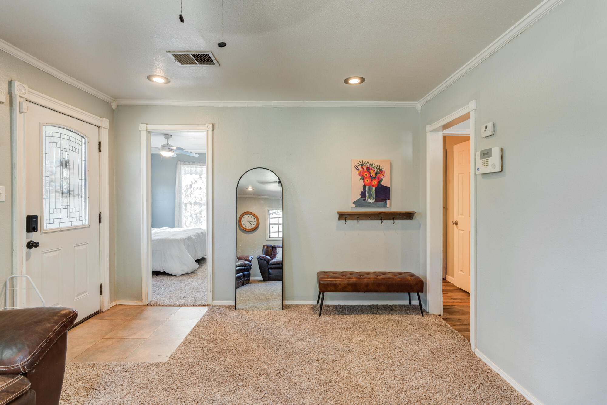 2019 40th Street Lubbock, TX 79412 - Photo 10 of 33 a bedroom with furniture and a chandelier