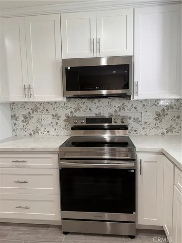 a stove top oven sitting inside of a kitchen