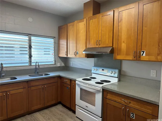 a kitchen with appliances cabinets and a sink