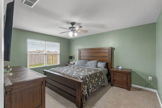 a bedroom with a bed and a table