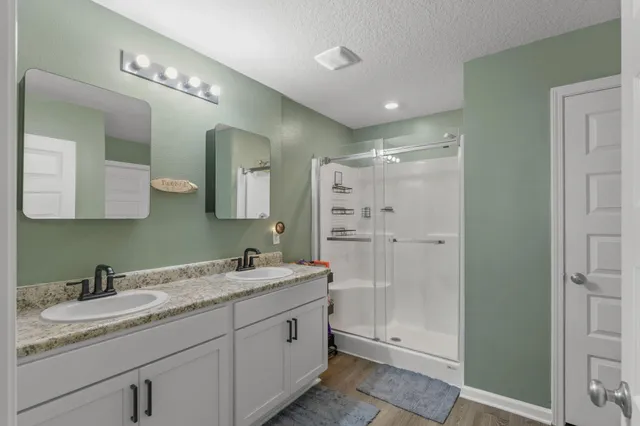 a bathroom with a double vanity sink and mirror