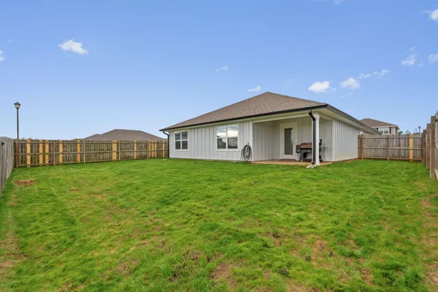 a view of a house with a backyard