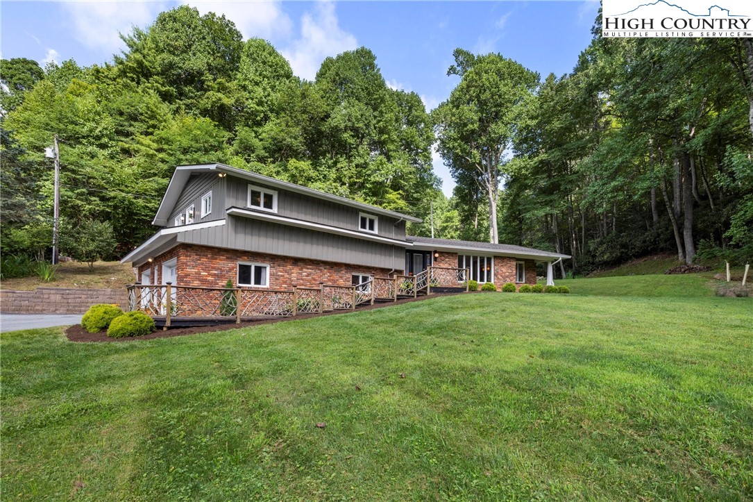 a house with green field in front of it