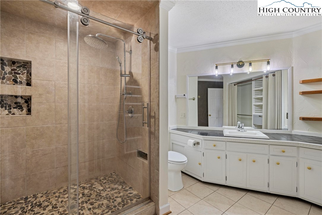 956 Jordan V Cook Road Boone, NC 28607 - Photo 23 of 50 a spacious bathroom with a granite countertop sink mirror and shower