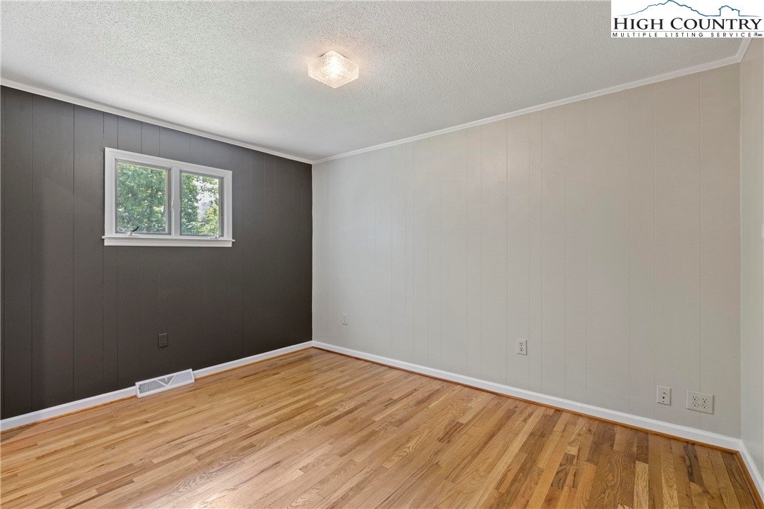 956 Jordan V Cook Road Boone, NC 28607 - Photo 29 of 50 an empty room with wooden floor and windows