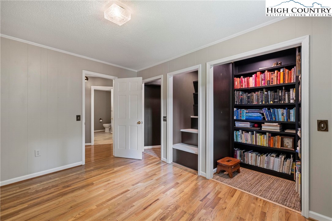 956 Jordan V Cook Road Boone, NC 28607 - Photo 31 of 50 a room with bookshelf and a wooden floor