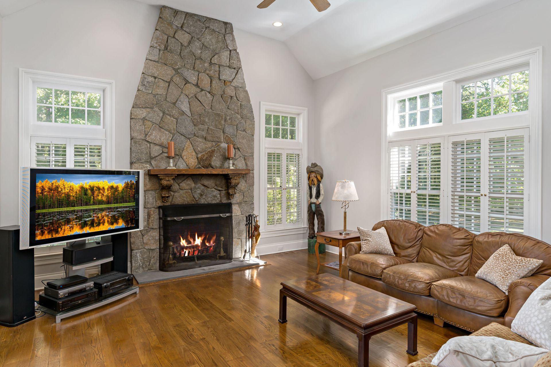 318 Ridgefield Road Wilton, CT 06897 - Photo 20 of 51 a living room with furniture a flat screen tv and a fireplace