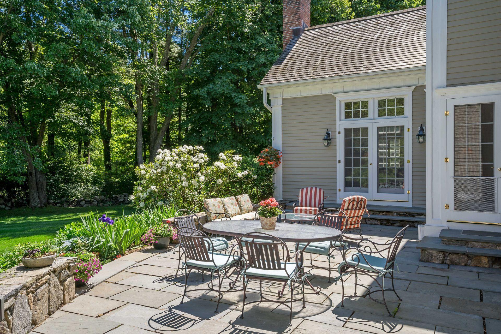 318 Ridgefield Road Wilton, CT 06897 - Photo 23 of 51 a view of a patio with table and chairs and potted plants