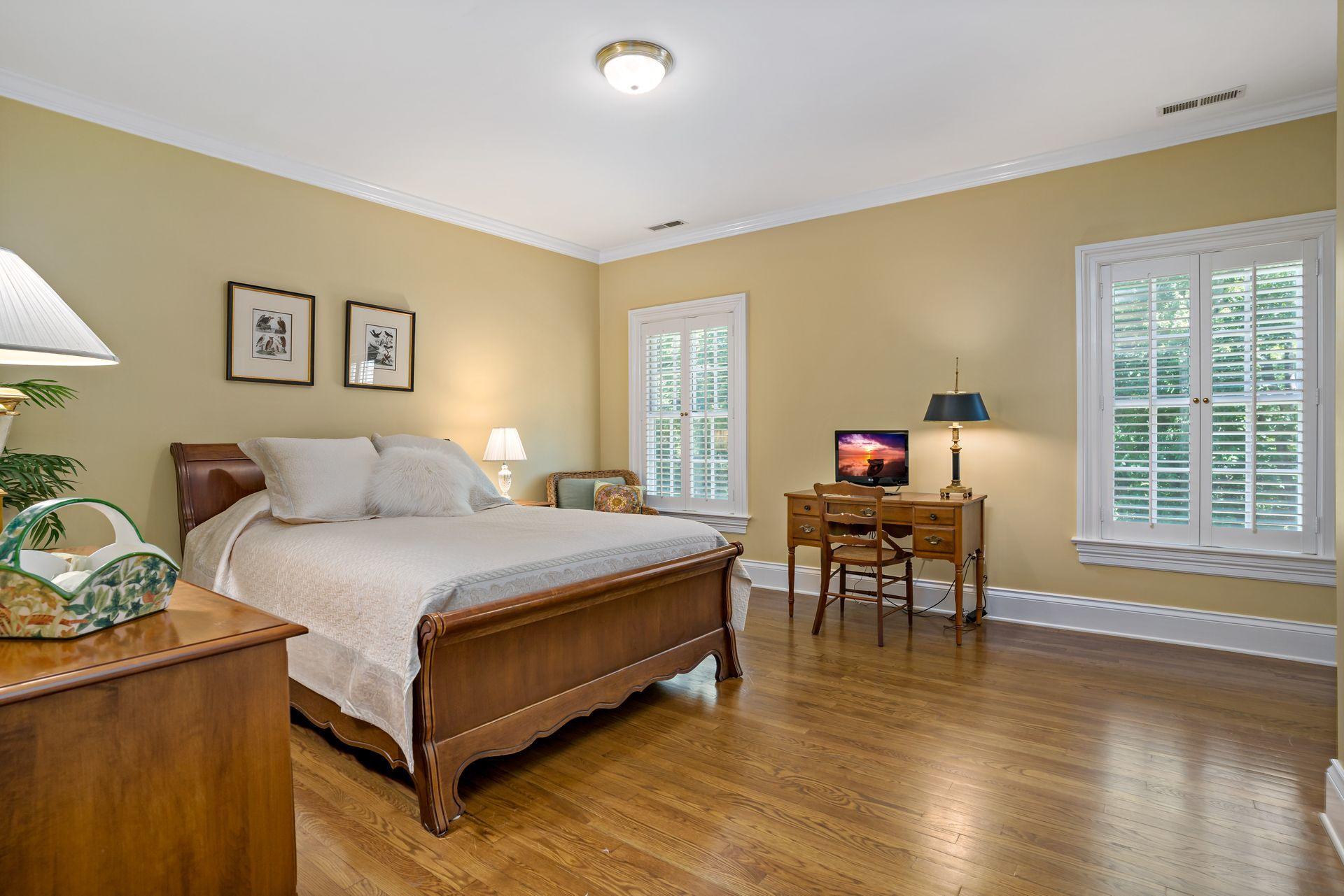 318 Ridgefield Road Wilton, CT 06897 - Photo 36 of 51 a bedroom with a bed and a table in it with wooden floor