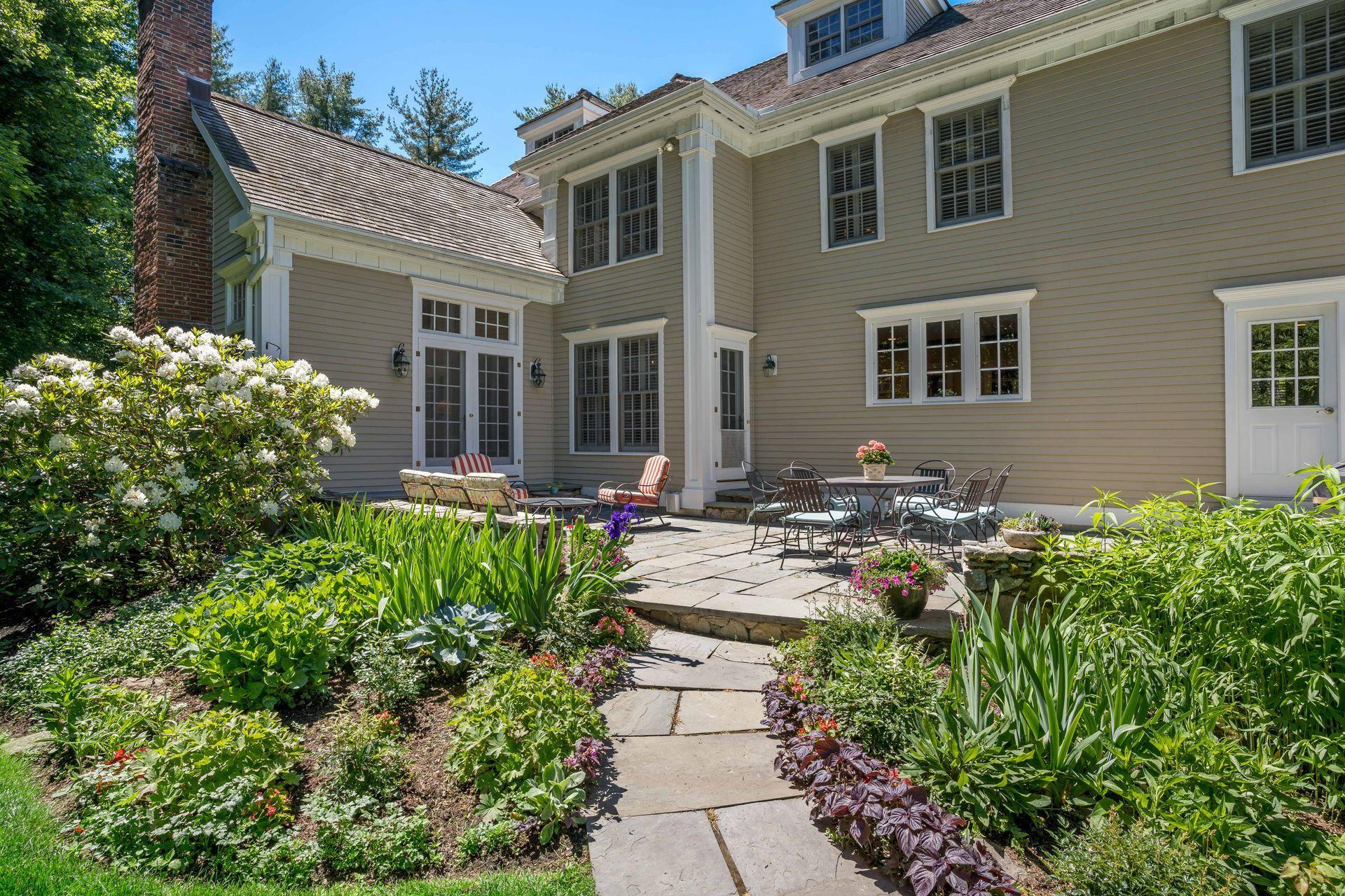 318 Ridgefield Road Wilton, CT 06897 - Photo 43 of 51 a view of a house with sitting area and garden