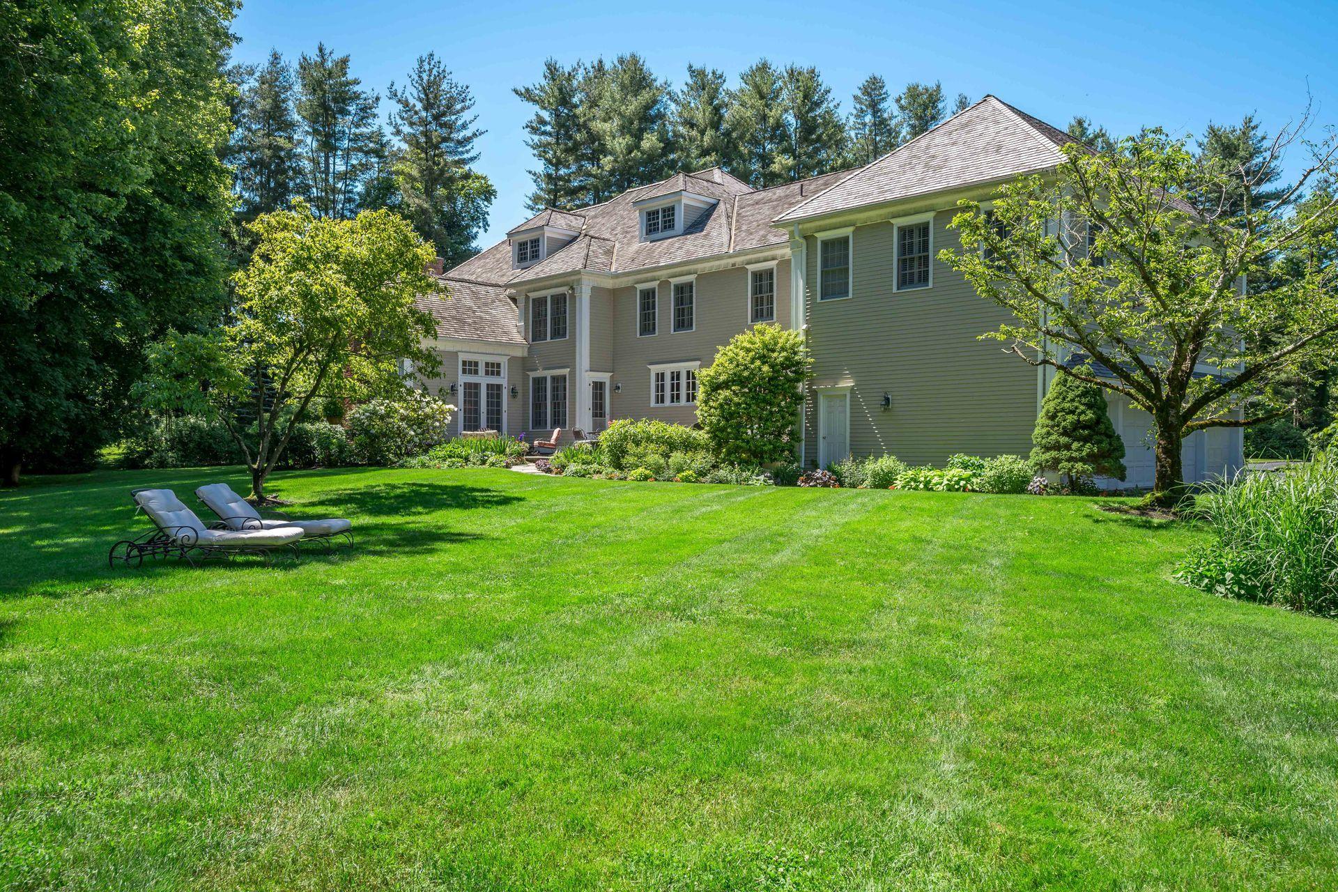 318 Ridgefield Road Wilton, CT 06897 - Photo 49 of 51 a front view of house with yard and green space