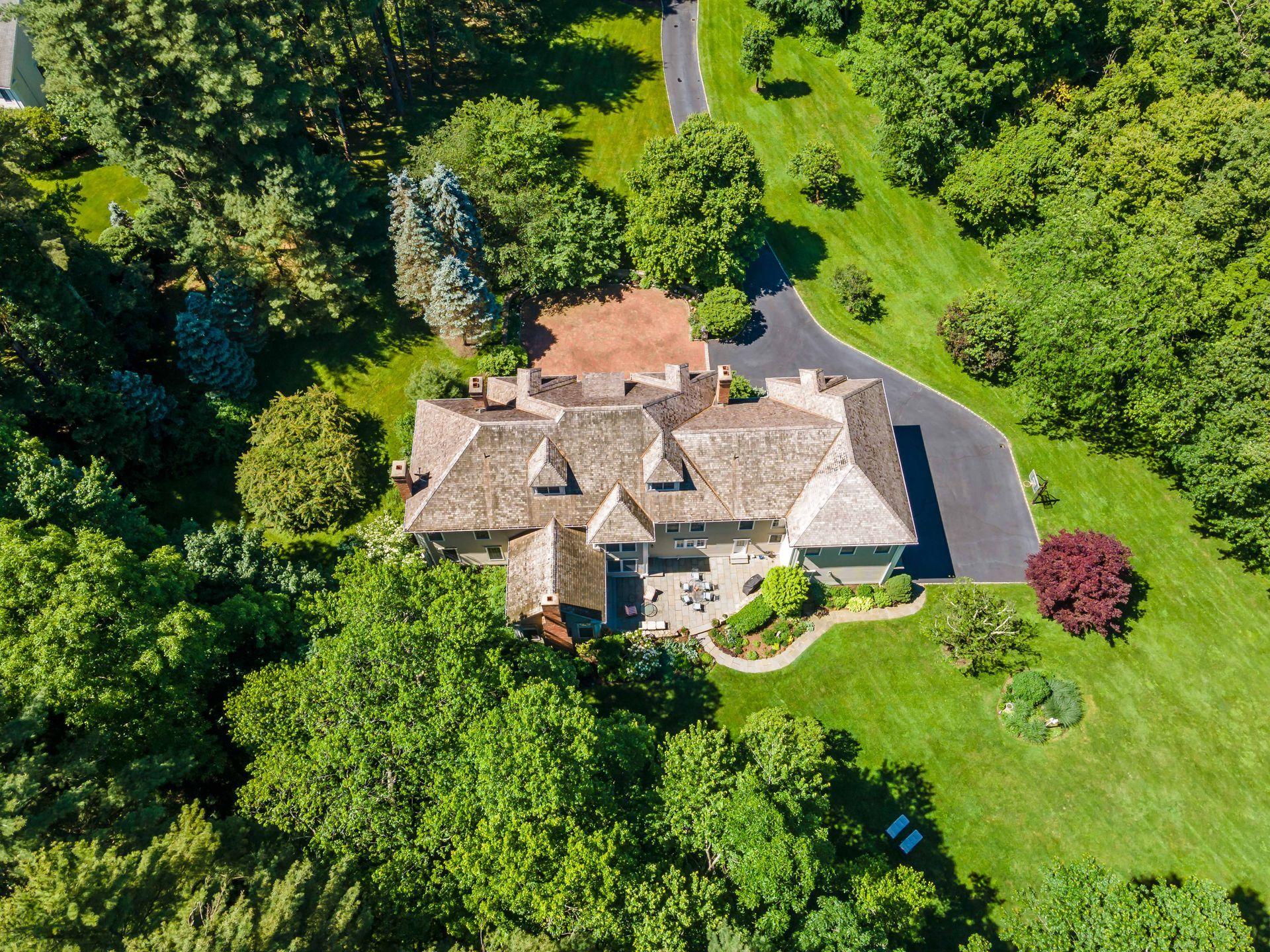 318 Ridgefield Road Wilton, CT 06897 - Photo 50 of 51 an aerial view of a house with swimming pool and garden