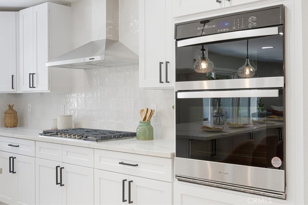 25032 Crystal Circle Lake Forest, CA 92630 - Photo 11 of 54 a kitchen with granite countertop white cabinets and white appliances