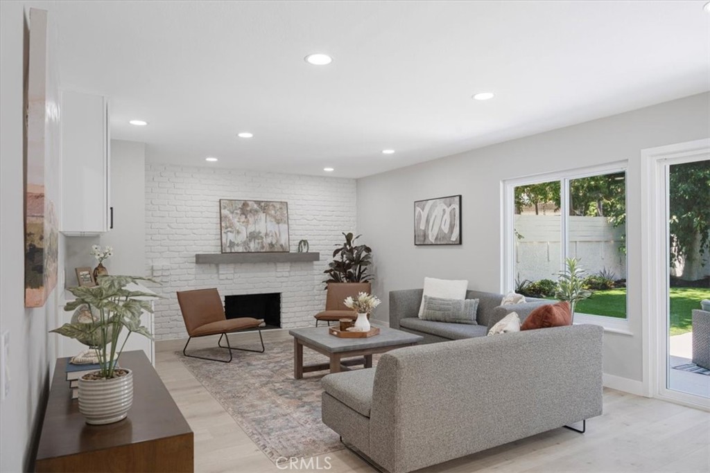 25032 Crystal Circle Lake Forest, CA 92630 - Photo 15 of 54 a living room with furniture flower pot and a fireplace