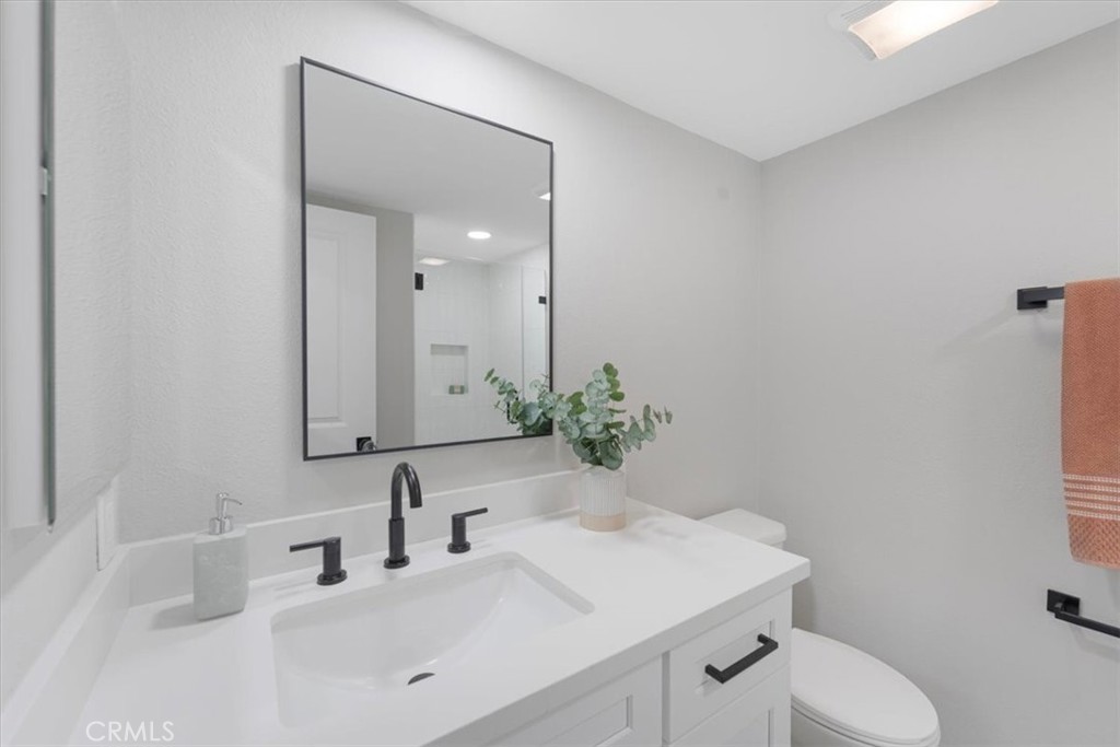 25032 Crystal Circle Lake Forest, CA 92630 - Photo 20 of 54 a bathroom with a toilet sink and mirror