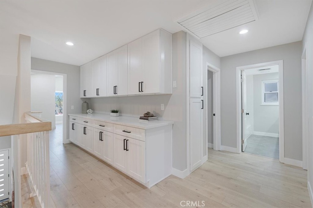 25032 Crystal Circle Lake Forest, CA 92630 - Photo 23 of 54 a kitchen with stainless steel appliances a stove a sink and white cabinets