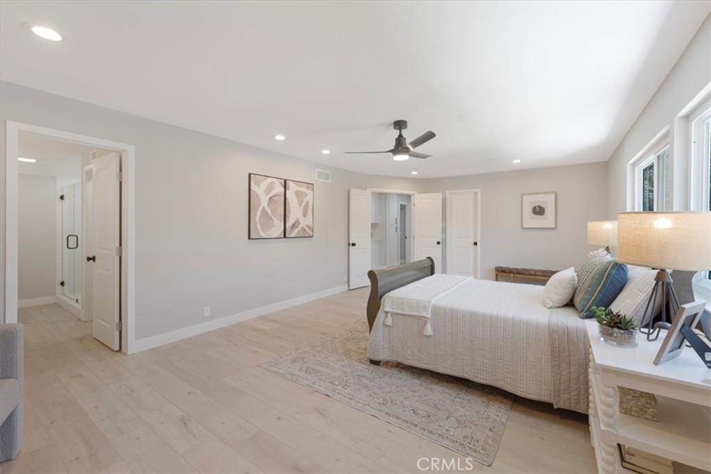 25032 Crystal Circle Lake Forest, CA 92630 - Photo 26 of 54 a spacious bedroom with a bed and a lamp
