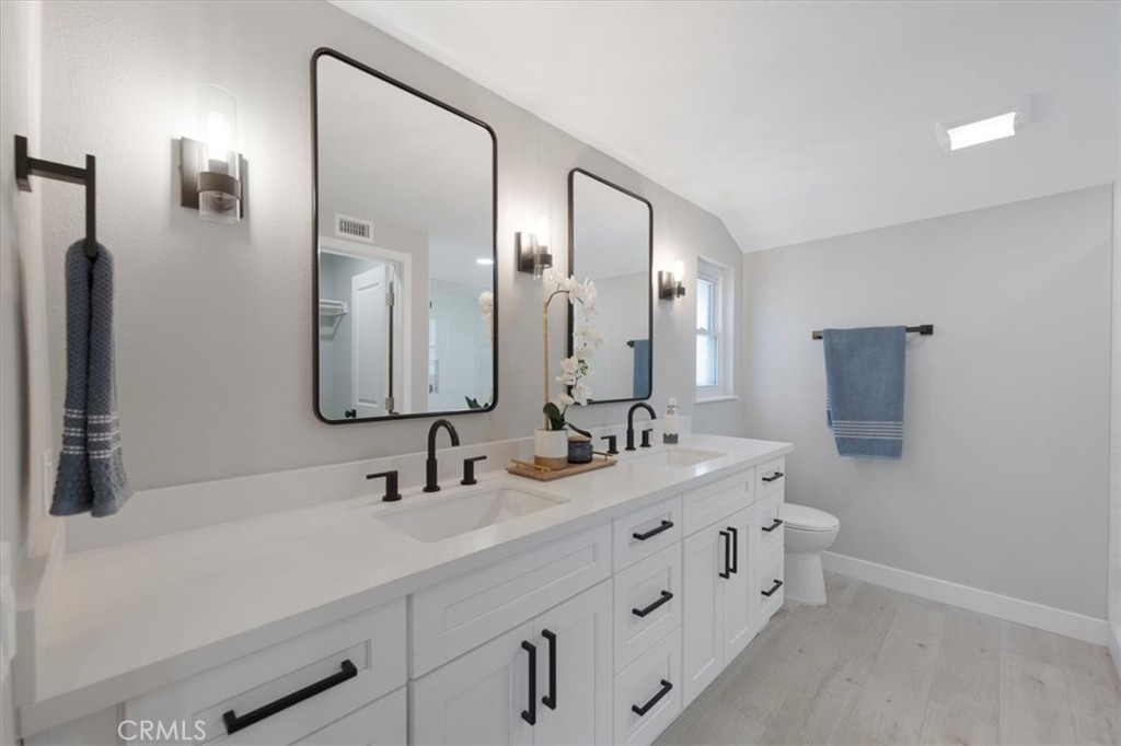 25032 Crystal Circle Lake Forest, CA 92630 - Photo 27 of 54 a bathroom with double vanity sinks and a mirror