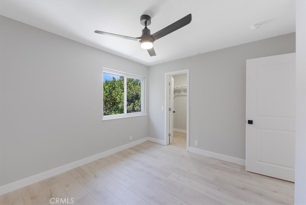 25032 Crystal Circle Lake Forest, CA 92630 - Photo 30 of 54 an empty room with windows and ceiling fan