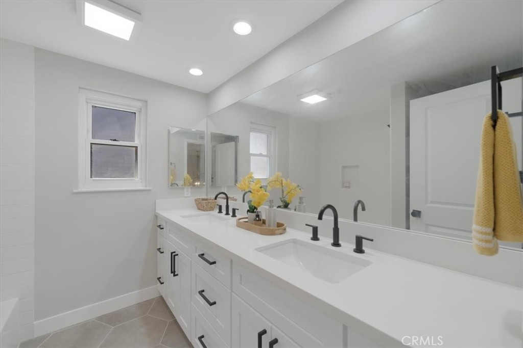 25032 Crystal Circle Lake Forest, CA 92630 - Photo 33 of 54 a bathroom with double sink and a mirror
