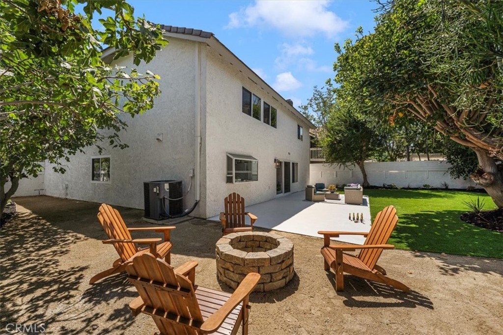 25032 Crystal Circle Lake Forest, CA 92630 - Photo 41 of 54 a view of a patio with couches table and chairs with wooden fence and plants